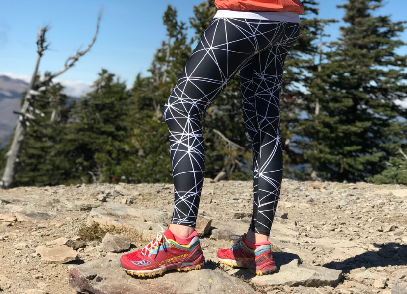 Woman wearing la sportiva trail runners and black and white geometric hiking leggings